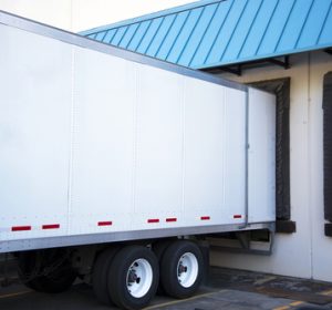 White,long,semi,trailer,with,an,open,door,stand,close