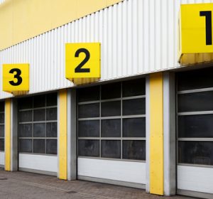 Industrial,warehouse,building,with,numbered,roll Up,doors