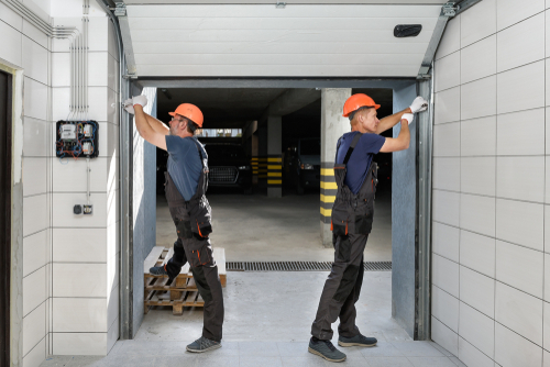 Workers,are,installing,lifting,gates,of,the,garage.