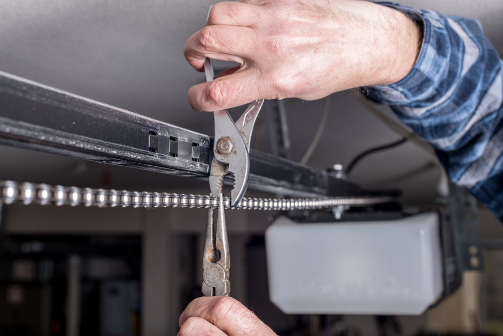 Maintenance,is,done,of,a,home,garage,door,chain,with